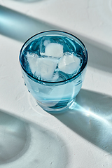 Image showing blue glass of cold water with ice cubes