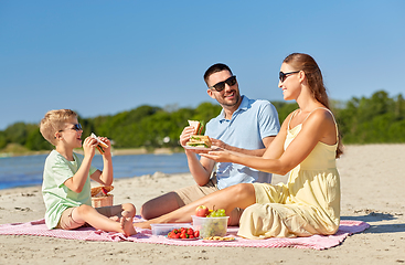 Image showing happy family having picnic on summer beach