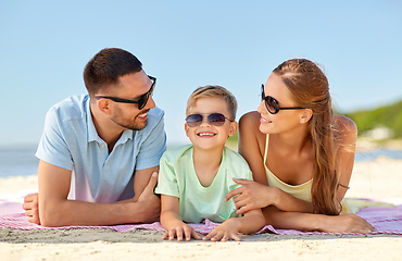 Image showing happy family lying on summer beach