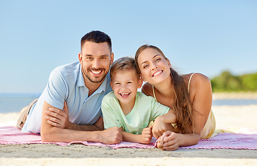 Image showing happy family lying on summer beach