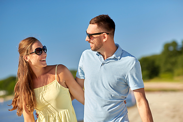 Image showing happy couple hugging on summer beach