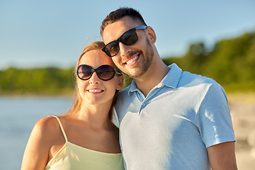 Image showing happy couple hugging on summer beach