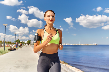 Image showing woman with earphones and smartphone running