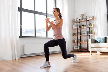 Image showing young woman exercising at home