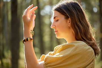 Image showing woman or witch performing magic ritual in forest