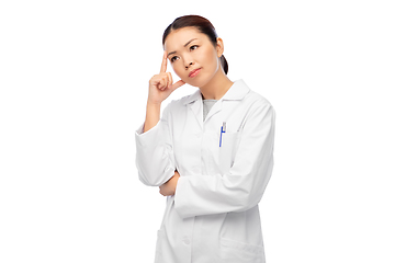 Image showing thinking asian female doctor in white coat