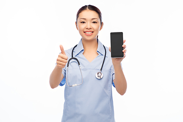 Image showing asian female nurse with smartphone shows thumbs up