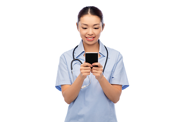 Image showing happy asian female doctor or nurse with smartphone