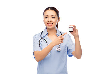 Image showing smiling asian female doctor or nurse with medicine