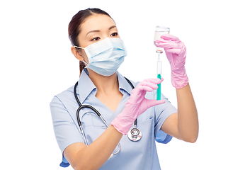 Image showing asian nurse in mask with medicine in syringe