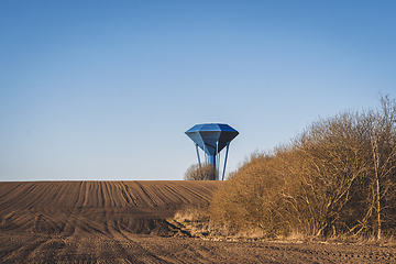 Image showing Blue water tower om a dry field