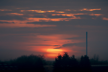 Image showing Beautiful sunset over an industrial facility