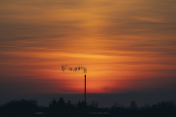 Image showing Smoke from a chimey in a beautiful sunset