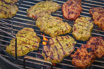 Image showing Grilled pork chops with spices on a hot grill