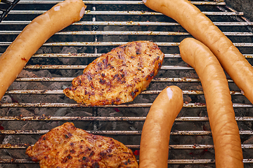 Image showing Barbeque sausages and pork chops