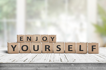 Image showing Enjoy yourself wriiten on wooden blocks