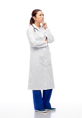 Image showing thinking asian female doctor in white coat