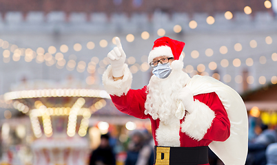 Image showing man in costume of santa claus wearing medical mask