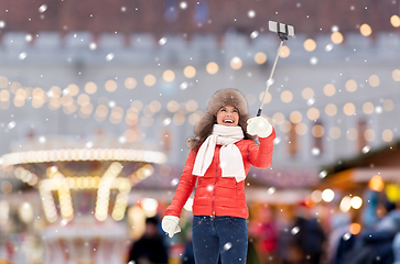 Image showing happy woman taking selfie over christmas market