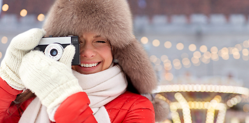 Image showing happy woman with film camera over christmas market