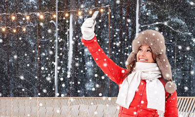 Image showing happy woman taking selfie in winter at ice rink