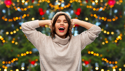 Image showing happy woman in hat and sweater on christmas