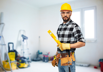 Image showing male worker or builder in helmet with level