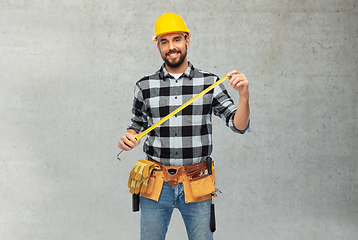 Image showing happy male worker or builder in helmet with ruler