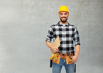 Image showing male worker or builder in helmet with clipboard