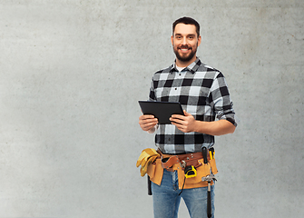 Image showing happy builder with tablet computer and tools