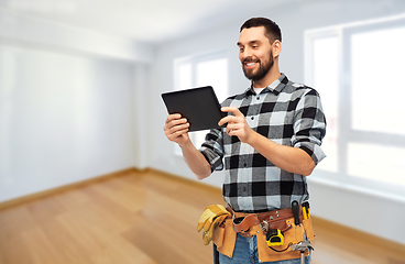 Image showing happy builder with tablet computer and tools