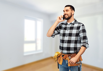 Image showing builder in helmet calling on smartphone