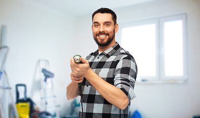 Image showing happy man, worker or builder with drill