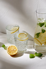 Image showing glasses with lemon water and peppermint on table