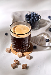 Image showing glass of coffee, brown sugar and blueberries