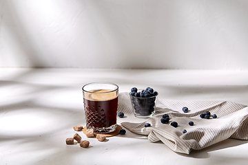 Image showing glass of coffee, brown sugar and blueberries
