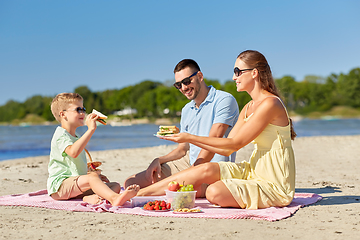 Image showing happy family having picnic on summer beach