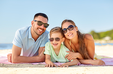 Image showing happy family lying on summer beach