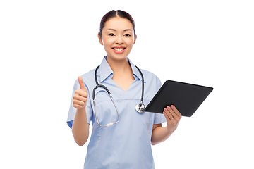 Image showing asian female nurse with tablet pc shows thumbs up