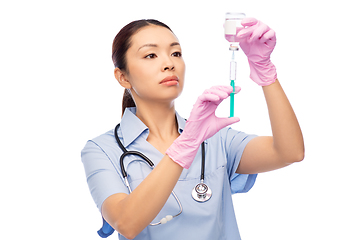 Image showing asian female nurse with medicine and syringe