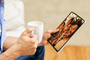 Image showing man with tablet pc having video call with friends