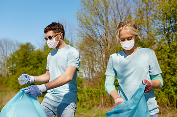 Image showing volunteers with garbage bags cleaning park area