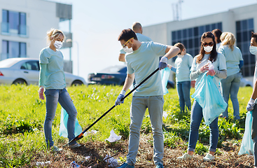 Image showing volunteers with garbage bags cleaning park area