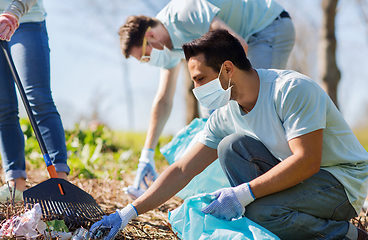 Image showing volunteers with garbage bags cleaning park area