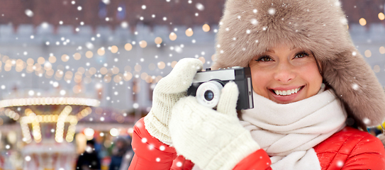 Image showing happy woman with film camera over christmas market