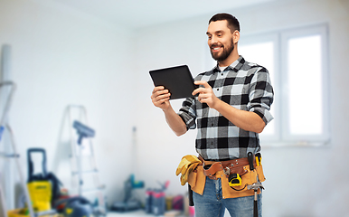 Image showing happy builder with tablet computer and tools