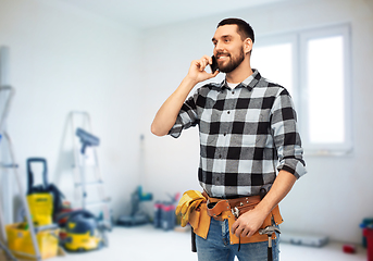 Image showing builder in helmet calling on smartphone