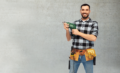 Image showing happy male worker or builder with drill and tools