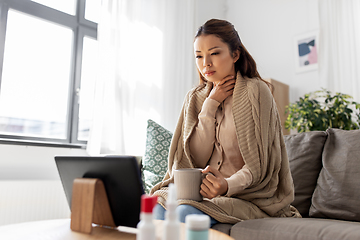 Image showing sick woman having video call on tablet pc at home