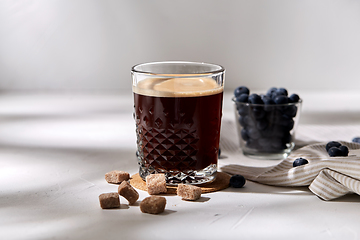 Image showing glass of coffee, brown sugar and blueberries